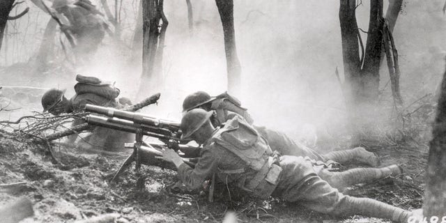 U.S. soldiers of the 23rd Infantry, 2nd Division, firing a 37mm machine gun at a German position in the Argonne Forest, during the Meuse-Argonne offensive, Sept. 26-Nov. 11, 1918. 