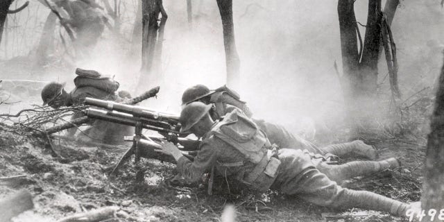 U.S. soldiers of the 23rd Infantry, 2nd Division, firing a 37mm machine gun at a German position in the Argonne Forest, during the Meuse-Argonne offensive, Sept. 26-Nov. 11, 1918. 