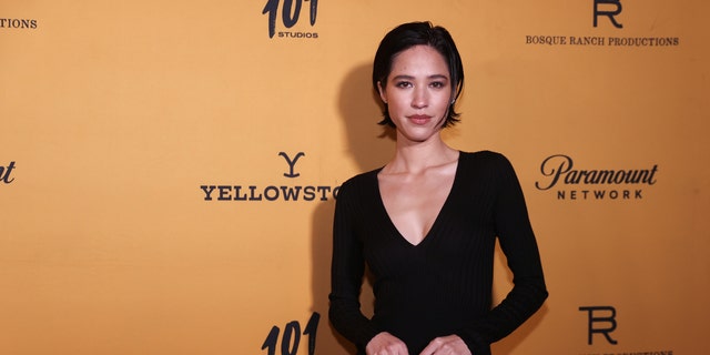 Kelsey Asbille in a black dress with short hair on the red carpet