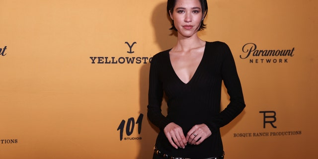 Kelsey Asbille in a black dress with short hair on the red carpet