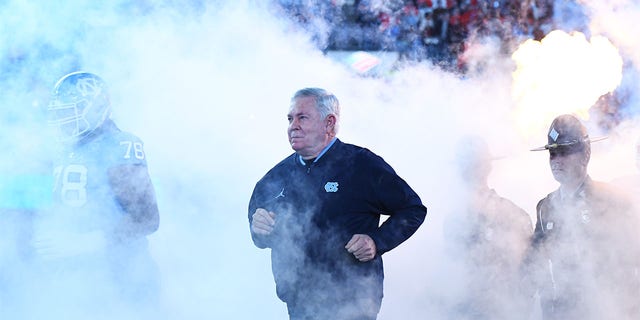 Head coach Mack Brown of the North Carolina Tar Heels runs onto the field for the ACC championship game against the Clemson Tigers at Bank of America Stadium Dec. 3, 2022, in Charlotte, N.C. 