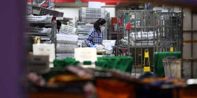 Postal worker at processing facility