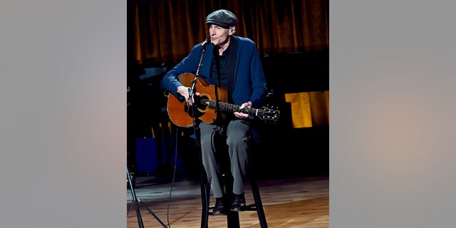 James Taylor performed on stage in honor of Joni Mitchell.