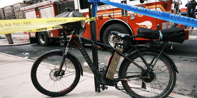 An electric bike with a lithium ion battery is parked outside a Bronx supermarket on March 06, 2023, in New York City. A fire caused by a lithium battery from an e-bike on April 10, 2023, has led to the death of two children. The fire occurred at a building in New York City.