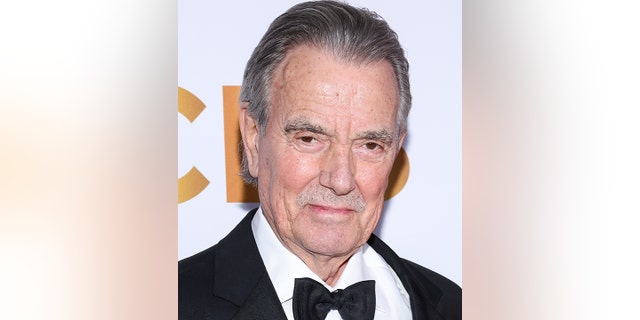 Eric Braeden on the red carpet in a classic black tuxedo with a stern look