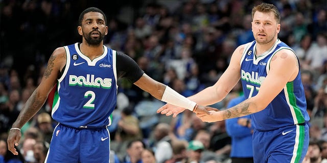 Kyrie Irving #2 of the Dallas Mavericks congratulates Luka Doncic #77 during the first half against the Charlotte Hornets at American Airlines Center on March 24, 2023 in Dallas, Texas. 
