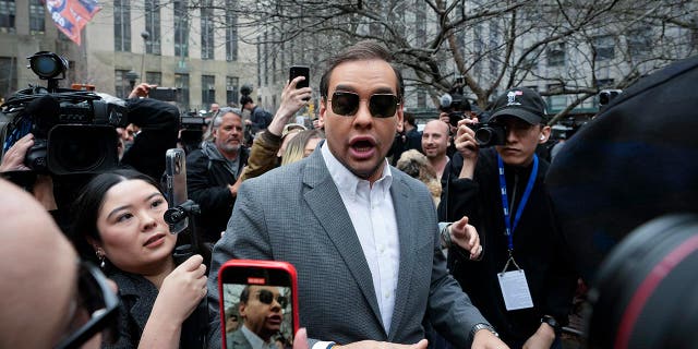 U.S. Rep. George Santos (R-NY) walks through the crowd gathered outside the courthouse where former President Donald Trump will arrive for his arraignment, April 4, 2023, in New York City.
