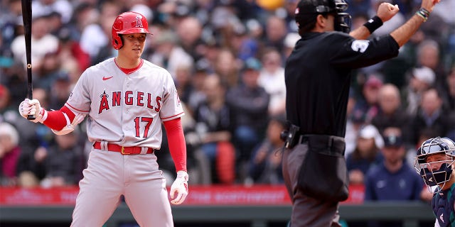 Umpire Pat Hoberg calls Shohei Ohtani of the Los Angeles Angels for a pitch clock violation during the sixth inning against the Seattle Mariners at T-Mobile Park April 5, 2023, in Seattle.