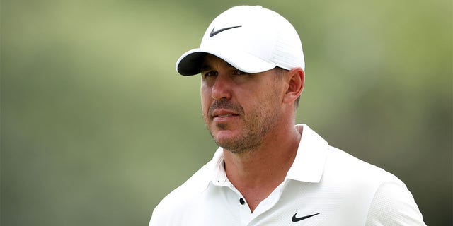Brooks Koepka looks on from the 18th green during the second round of the 2023 Masters Tournament at Augusta National Golf Club in Augusta, Georgia, on Friday.