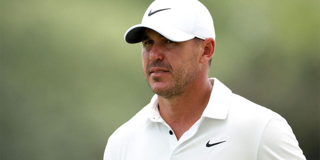 Brooks Koepka looks on from the 18th green during the second round of the 2023 Masters Tournament at Augusta National Golf Club in Augusta, Georgia, on Friday.