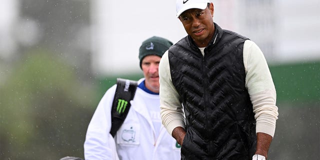 Tiger Woods of the United States looks on from the 18th green during the weather-delayed second round continuation of the 2023 Masters Tournament at Augusta National Golf Club on April 8, 2023 in Augusta, Georgia. 