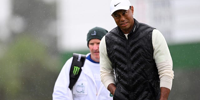 Tiger Woods of the United States looks on from the 18th green during the continuation of the weather delayed second round of the 2023 Masters Tournament at Augusta National Golf Club on April 8, 2023, in Augusta, Georgia. 