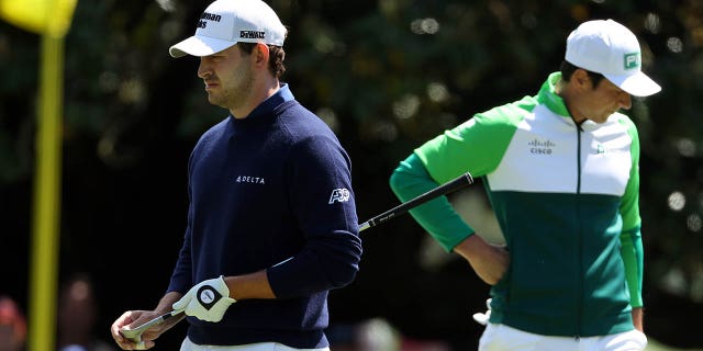 Patrick Cantlay, left, and Viktor Hovland look on from the first green during the final round of the 2023 Masters Tournament at Augusta National Golf Club in Augusta, Georgia, on Sunday.