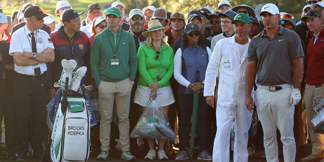 Brooks Koepka talks with his caddie Ricky Elliott on the 17th hole during the final round of the Masters Tournament at Augusta National Golf Club on April 9, 2023.