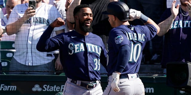 Jarred Kelenic of the Seattle Mariners is congratulated by Teoscar Hernandez following a home run against the Cubs at Wrigley Field on April 12, 2023, in Chicago.