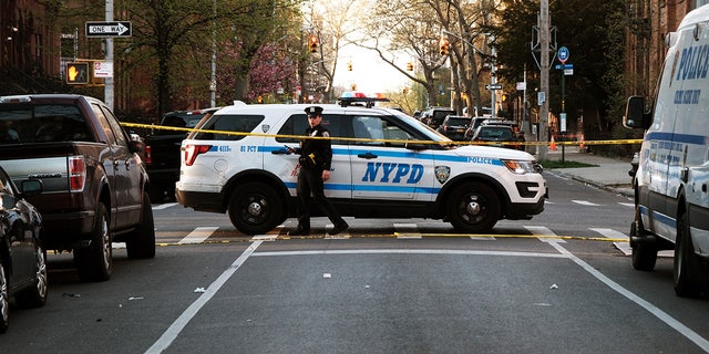 New York City police gather at the scene of a shooting of a 78-year-old man by police on April 13, 2023 in the Bedford-Stuyvesant neighborhood of the Brooklyn borough of New York City.