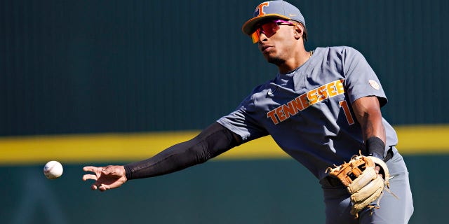 Christian Moore makes a throw to first base