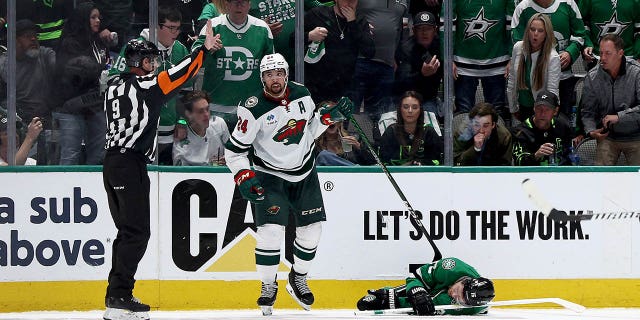 Joe Pavelski, #16 of the Dallas Stars, lies on the ice after a hit from Matt Dumba, #24 of the Minnesota Wild, in the second period in Game One of the First Round of the 2023 Stanley Cup Playoffs at American Airlines Center on April 17, 2023 in Dallas.