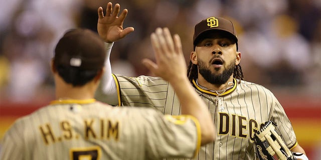 Fernando Tatis Jr. high fives a teammate