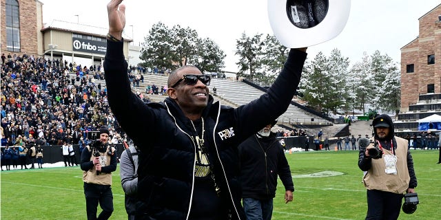 Deion Sanders waves to the Colorado crowd