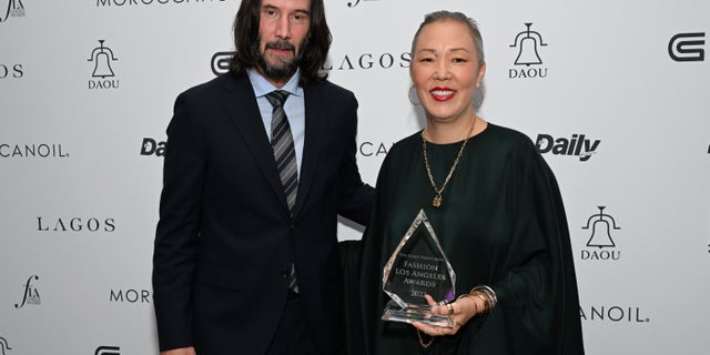 Keanu Reeves with stylist Jeanne Yang backstage