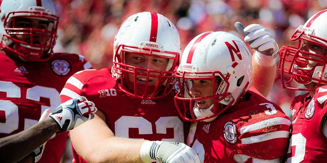 Nebraska Cornhuskers quarterback Taylor Martinez (3) is congratulated by offensive lineman Cole Pensick (62) during a game at Memorial Stadium on September 15, 2012 in Lincoln, Nebraska.
