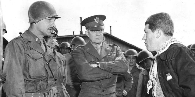 General Eisenhower (center) listens as a U.S. lieutenant questions a liberated slave laborer at, the German prison camp en Ohrdruf (Germany). This concentration camp was liberated on April 4, 1945.