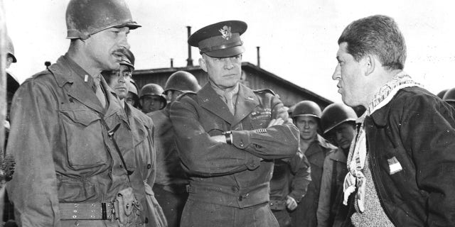 General Eisenhower (center) listens as a U.S. lieutenant questions a liberated slave laborer at, the German prison camp en Ohrdruf (Germany). This concentration camp was liberated on April 4, 1945.