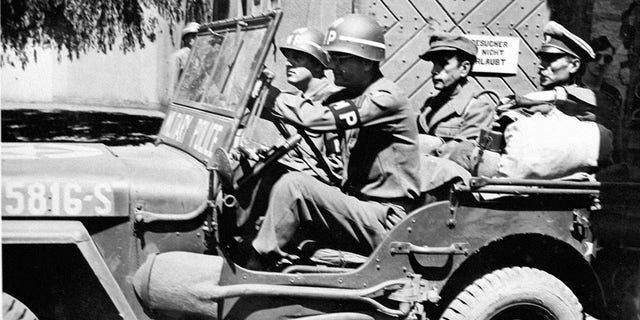 The former commander of the notorious German Buchenwald "horror" camp is taken away in a 15th U.S. Army jeep from Reinbach prison. Germany 1945. 