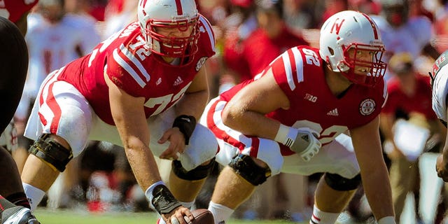 Nebraska offensive linemen Justin Jackson (72) and Cole Pensick (62) before throwing out the ball against the Arkansas State Red Wolves at Memorial Stadium on September 15, 2012 in Lincoln, Nebraska.  