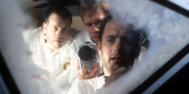 Bill Paxton, Kevin Bacon and Tom Hanks looking out the ship window in a scene from the film "Apollo 13" in 1995.