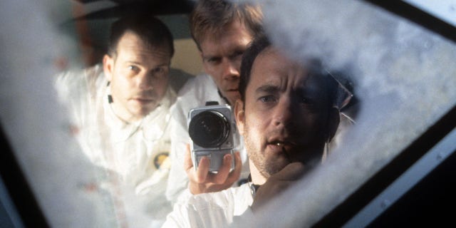 Bill Paxton, Kevin Bacon and Tom Hanks looking out the ship window in a scene from the film "Apollo 13" in 1995. 