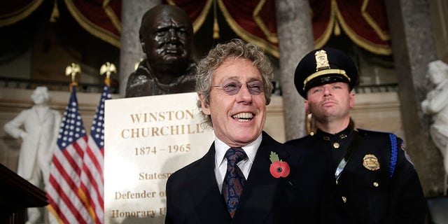 Roger Daltrey, lead singer of The Who, stands by a bust of former British Prime Minister Winston Churchill prior to a dedication ceremony in Statuary Hall of the U.S. Capitol on Oct. 30, 2013, in Washington, D.C. The bust was authorized and passed by the House of Representatives shortly before the 70th anniversary of Churchill's wartime address to Congress.  