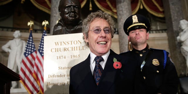 Roger Daltrey, lead singer of The Who, stands by a bust of former British Prime Minister Winston Churchill prior to a dedication ceremony in Statuary Hall of the U.S. Capitol on Oct. 30, 2013, in Washington, D.C. The bust was authorized and passed by the House of Representatives shortly before the 70th anniversary of Churchill's wartime address to Congress.  