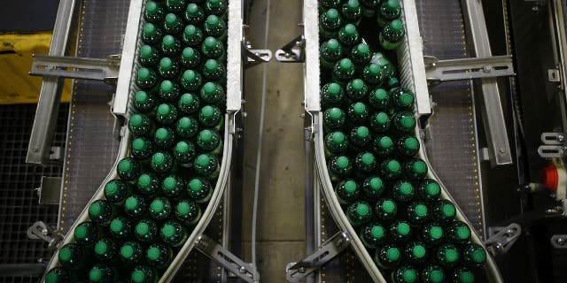 Canada Dry Ginger Ale bottles on a factory conveyor belt.