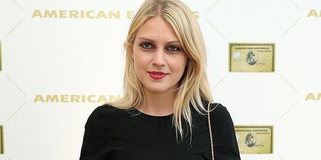 Fashion designer Katie Gallagher wears black dress and red lipstick