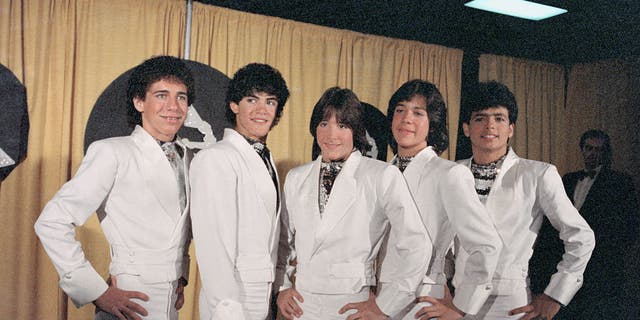 Ricky Melendez, Charlie Masso, Roy Rosello, Rey Reyes, and Robi Rosa of Menudo present award for "Best Recording for Children" at the 1984 Grammy Awards.