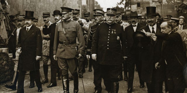 (Original Caption) 1/25/1918 in Pipus, France: General Pershing (1860-1948), Marshall (1880-1959), Joffre (1852-1931), and party arrive at Pipus, France, where Lafayette is buried.