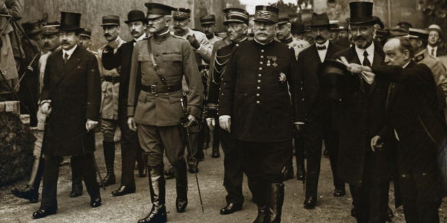 (Original Caption) 1/25/1918 in Pipus, France: General Pershing (1860-1948), Marshall (1880-1959), Joffre (1852-1931), and party arrive at Pipus, France, where Lafayette is buried.