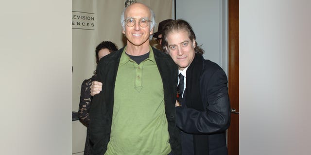 Larry David smiling next to Richard Lewis