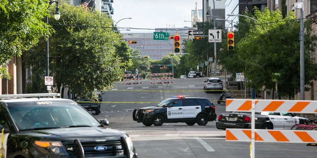 FILE PHOTO: Police block off an area of 6th Street after two shootings in downtown Austin, Texas. 