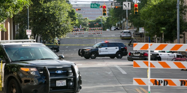 FILE PHOTO: Police block off an area of 6th Street after two shootings in downtown Austin, Texas.
