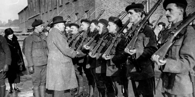 Sir H. Greenwood inspects the British soldiers in Ireland known as the "Black and Tans."