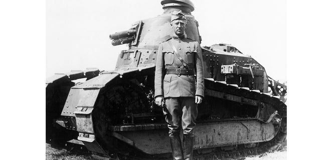 George S. Patton Jr. poses with a tank from his tank corps during a command as a lieutenant colonel in France during World War I. 