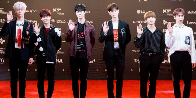 The members of Astro (JinJin, MJ, Cha Eunwoo, Moonbin, Rocky and Yoon Sanha) all wave on the red carpet in Los Angeles