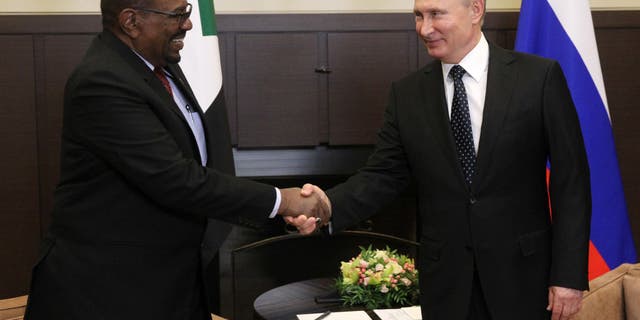 Russian President Vladimir Putin, right, greets former Sudanese President Omar al-Bashir during their meeting at Black Sea resort on Nov., 23, 2017 in Sochi, Russia. President al-Bashir was on his first state visit to Russia. Bashir was ousted in 2019.