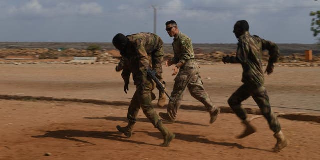 An Army instructor with the 10th Mountain Division coaches members of the Djibouti armed forces.