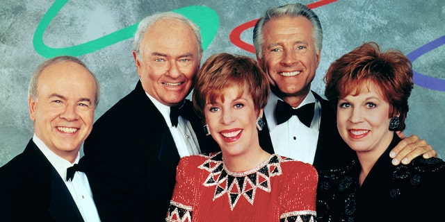 The Carol Burnett Show cast smiling while standing close to each other