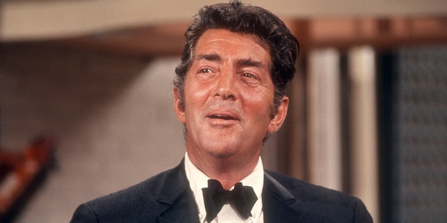 Dean Martin in a suit and bow tie singing