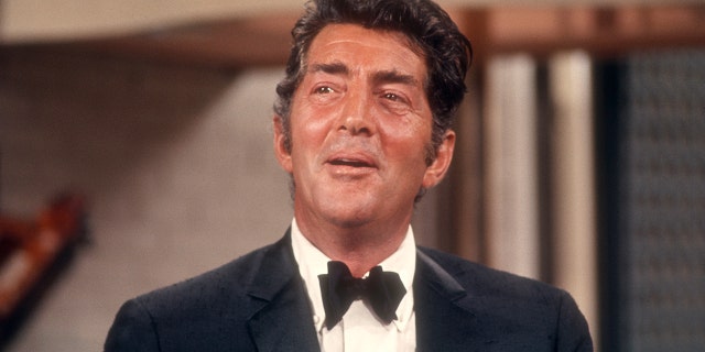 Dean Martin in a suit and bow tie singing